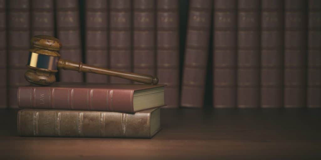 Gavel on the background of vintage lawyer books. Concept of law