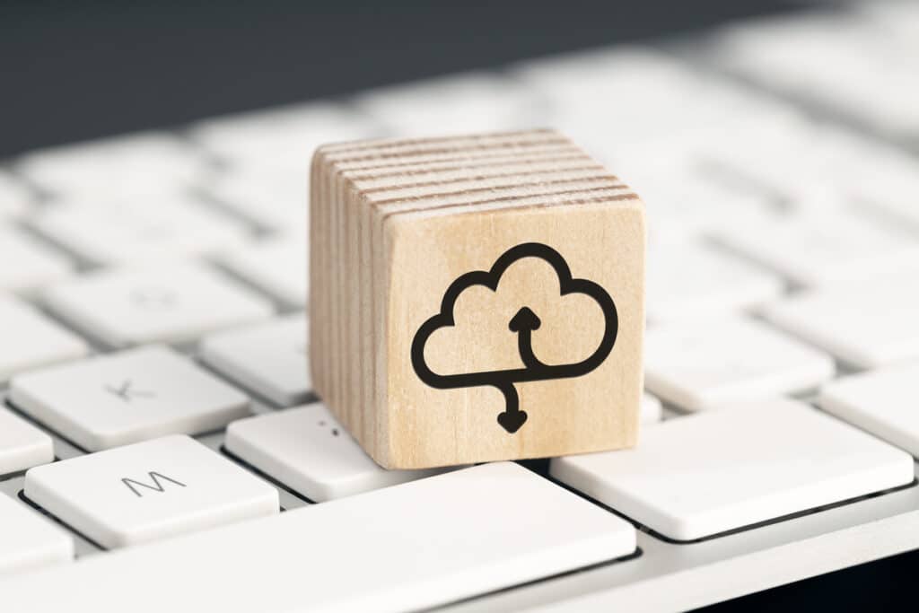 A wooden block with a cloud compliance symbol on it